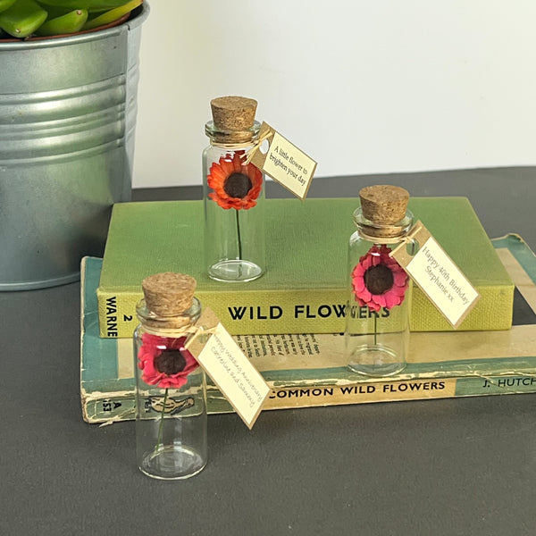 Tiny paper mulberry paper gerbera daisy in a bottle with personalised tag