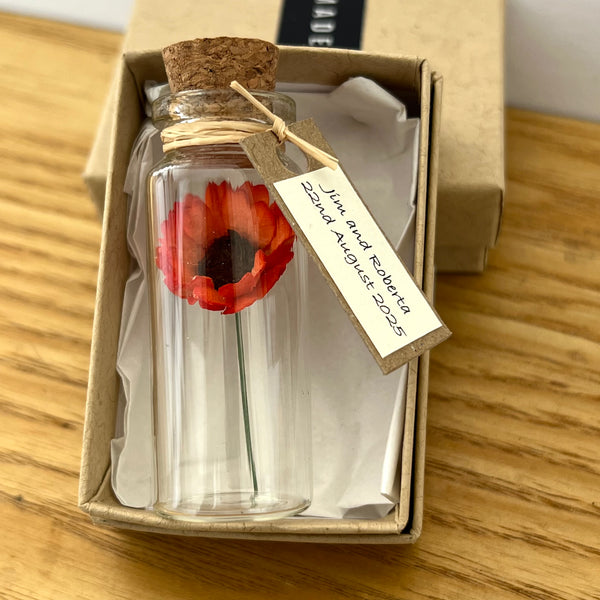 tiny orange gerbera daisy in a bottle with customised gift tag