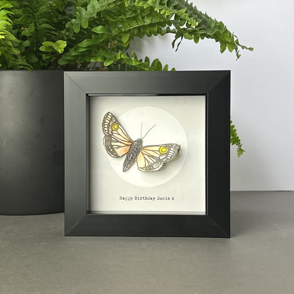 Customisable line of text beneath framed moth artwork, with full moon and literary-inspired moth illustration