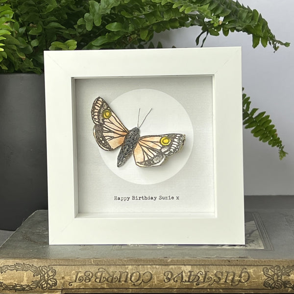 Framed hand-drawn moth artwork with book page collage wings, full moon background, and personalised text beneath in white frame