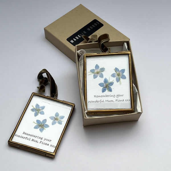 Forget-me-not artwork in brass frame tied with velvet ribbon ready to gift