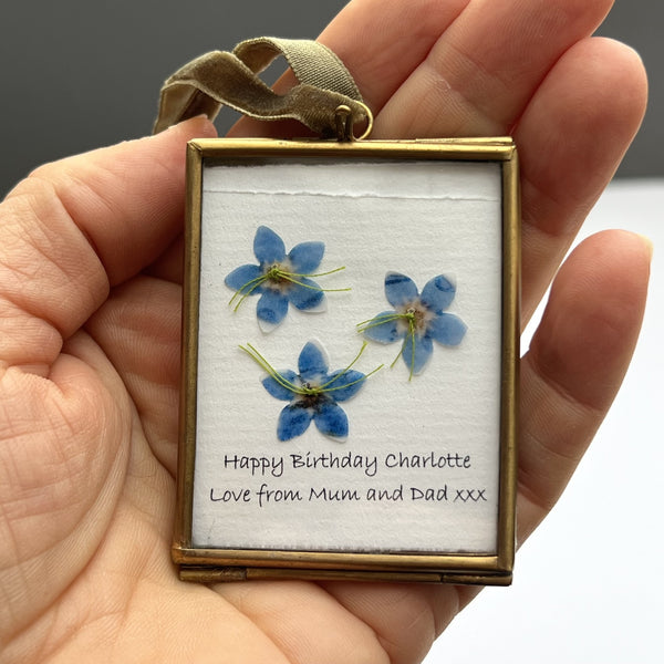 Hand-stitched forget-me-not flowers on white laid paper for personalised gift