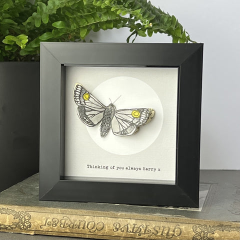Framed hand-drawn moth artwork with book page collage wings, full moon background, and personalised text beneath